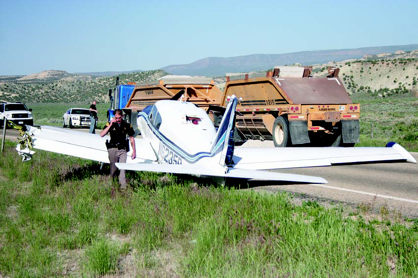 Utah Highway Patrol Trooper Jon Gardiner documents damage to an airplane after the pilot made an emergency landing on U.S. Highway 191 and collided with a truck hauling gravel. The incident restricted traffic north of Vernal Wednesday morning until after 10 a.m. The National Transportation Safety Board’s investigation report into the landing has not been released.